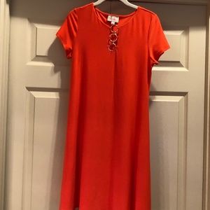 Orange dress with gold detail.